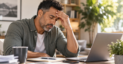 Man showing signs of stress and fatigue associated with elevated cortisol levels.